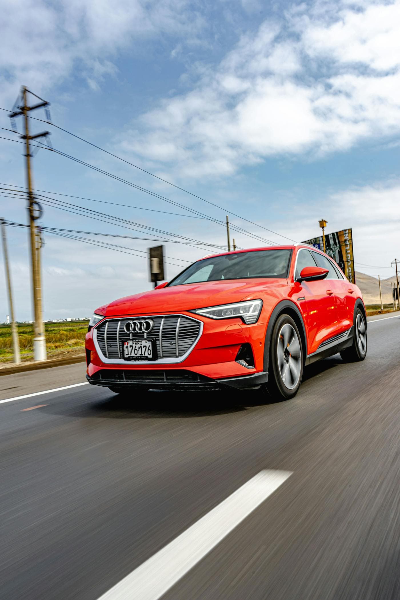 Red Audi e-tron driving on a road