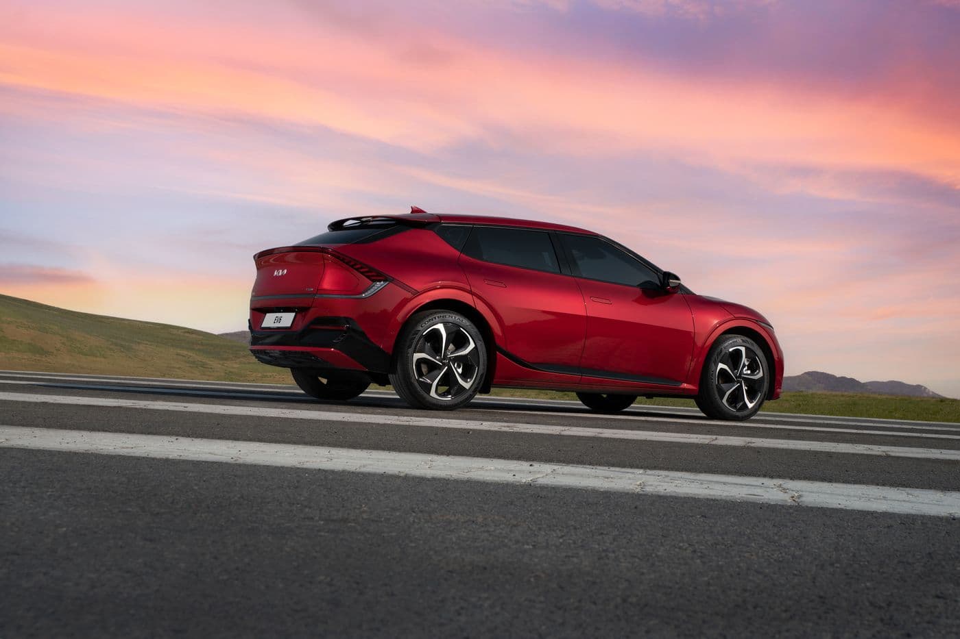 Red Kia EV6 driving on a highway
