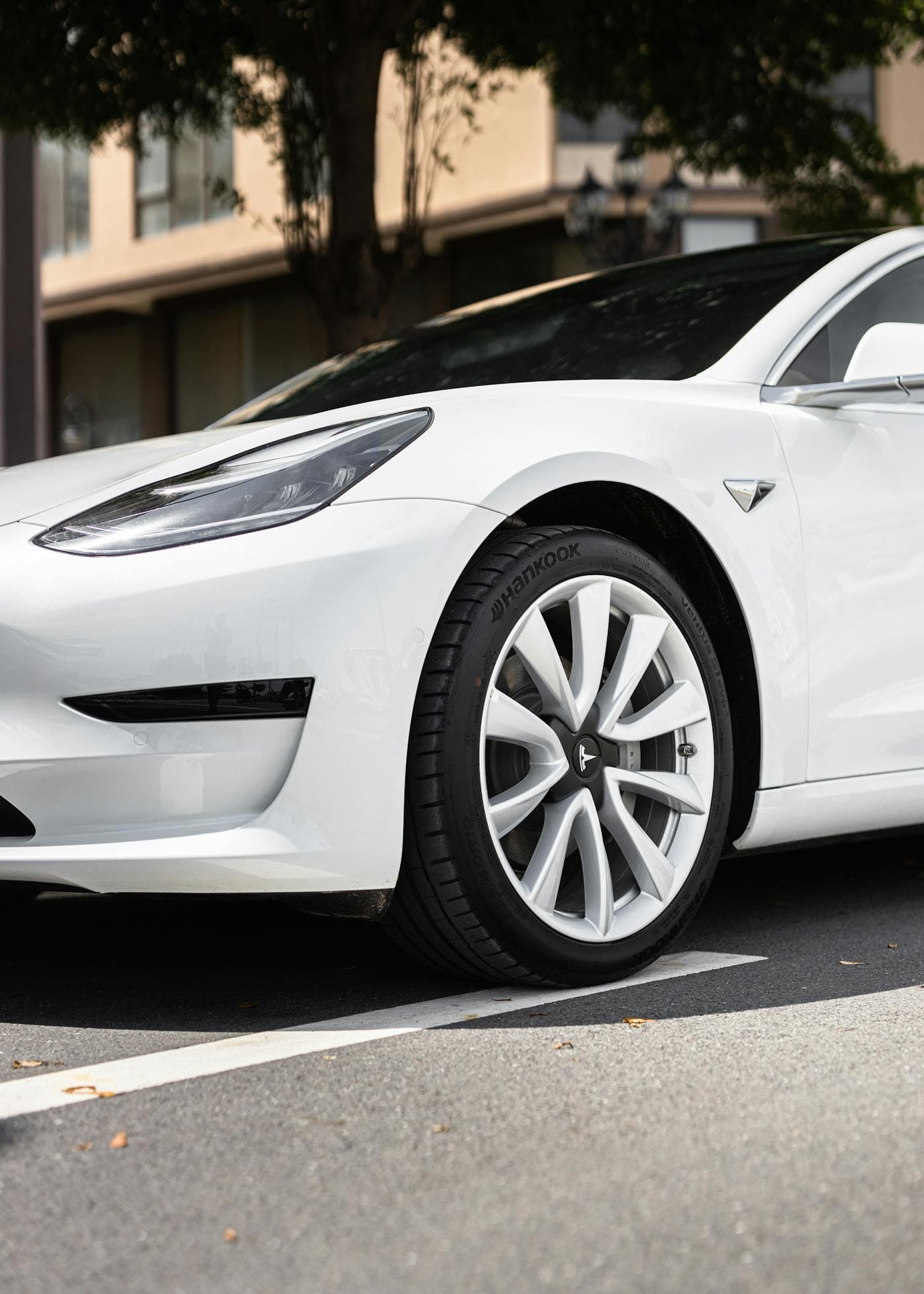 White Tesla Model 3 parked on a city street